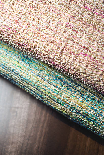 istock two rolls of colorful fabric on wooden table 473625644