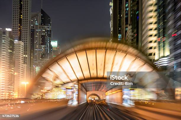 Illuminated Metro Station And Skyscrapers At Night Dubai Blurred Motion Stock Photo - Download Image Now