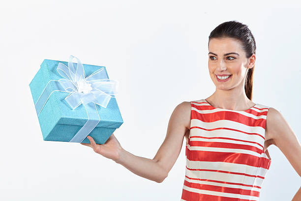 istock White striped dress woman holding blue gift box 473628200