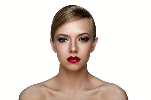 Beauty and health clean Skin of young female Model with smoky Eyes and red Lips on white Backgroud.