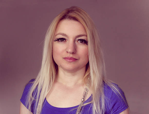 istock Blond woman gazing vacantly 473633266