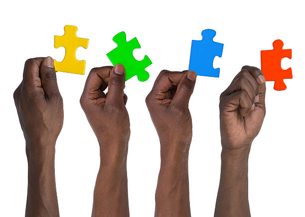 Man holding pieces of jigsaw puzzle