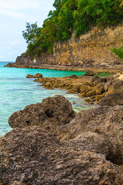 istock Big stones and green tropical rock island 473642786