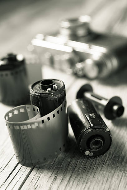 istock Old photo film rolls, cassette and retro camera on background. 473643216