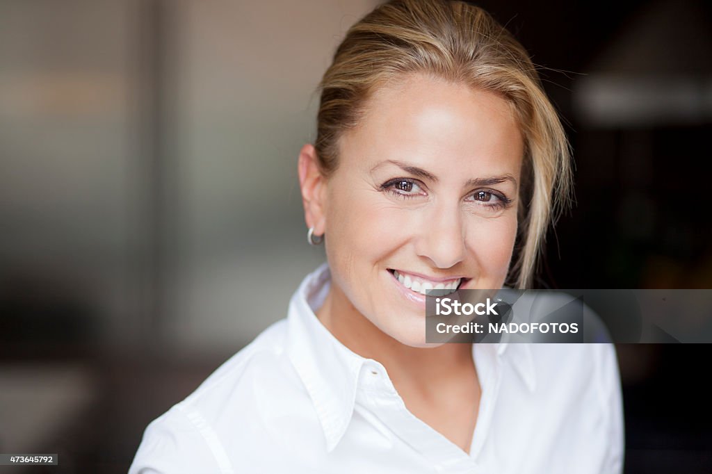 Portrait Of A Mature blond woman smiling at the camera 40-44 Years Stock Photo