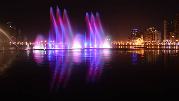istock colorful dancing fountain with mosque background 473648020