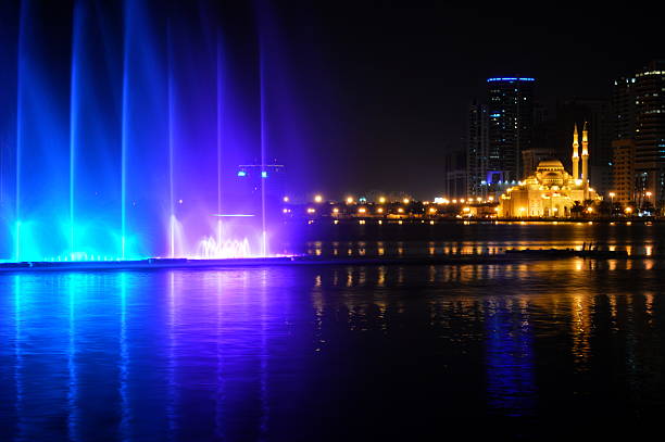 istock colorful dancing fountain with mosque background 473648032