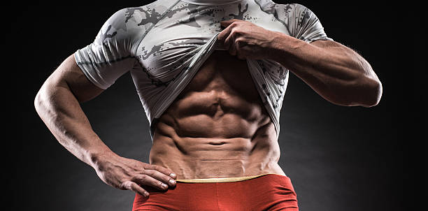 istock Muscular man in studio on dark background 473648156