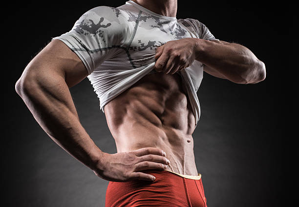 istock Muscular man in studio on dark background 473648160