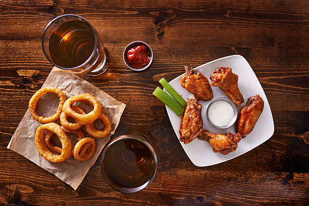 appetizer sample shot top down appetizer sampler with onion rings and chicken wings shot top down pub food stock pictures, royalty-free photos & images