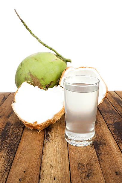 istock Coconut sliced with coconut juice on wooden table. 473649542