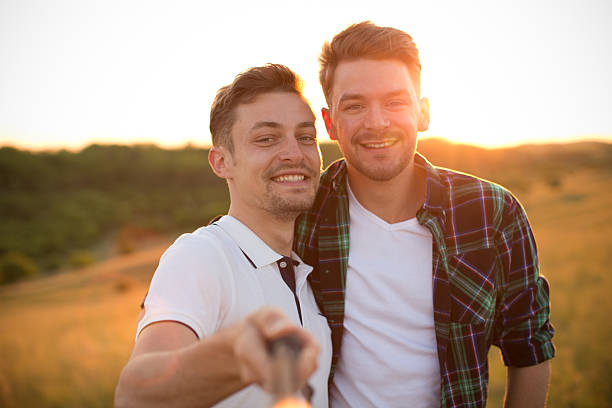 istock Young gay couple in a meadow. 473659896