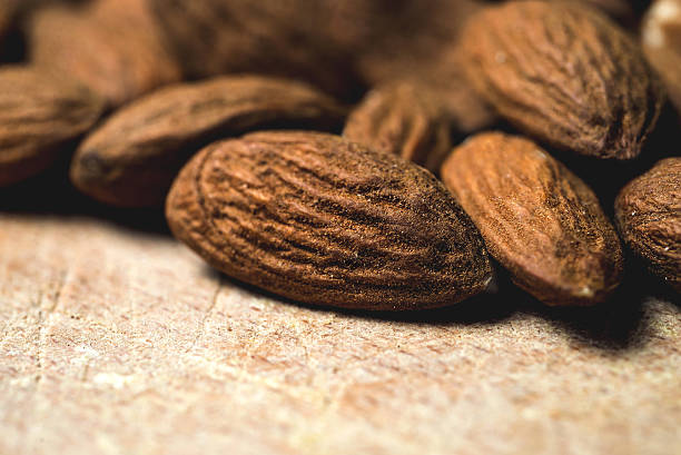 istock tasty almonds nuts on wooden background 473665464