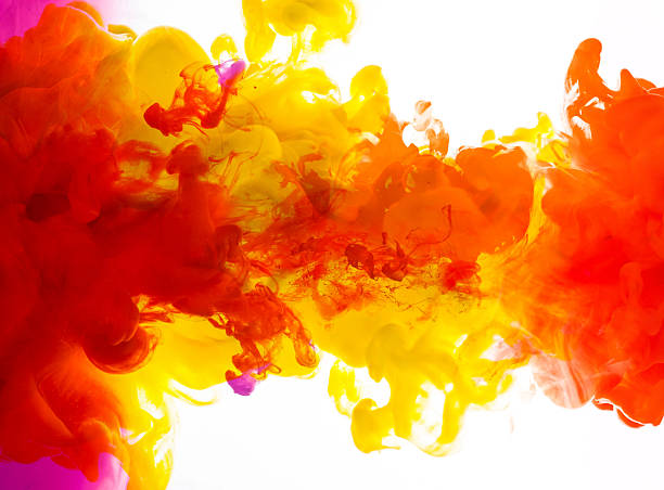 istock Red yellow and purple inks in water 473666020