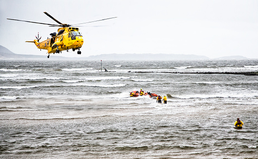 Burry Port, UK - April 12, 2015: helicopter rescue at sea with life boat and crew