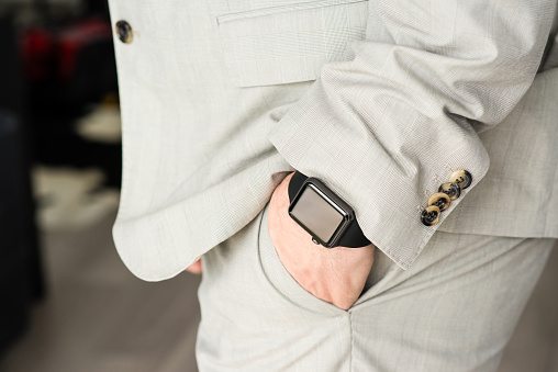 Ostfildern, Germany - May 14, 2015: A businessman is wearing the new Apple Watch, a black 42mm Apple Watch Sport. The Apple Watch is the latest device by computer and smartphone manufacturer Apple Computer and is available since April 2015.
