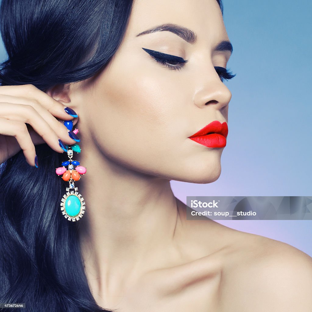 Lady with earring Fashion studio portrait of beautiful young woman with earring. Jewelry and accessories Fingernail Stock Photo