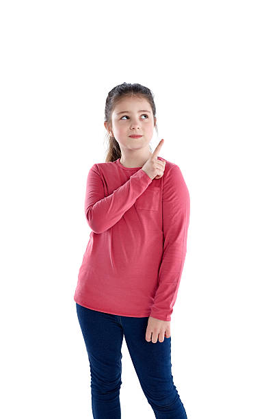 istock Young girl pointing at copyspace on white 473675308