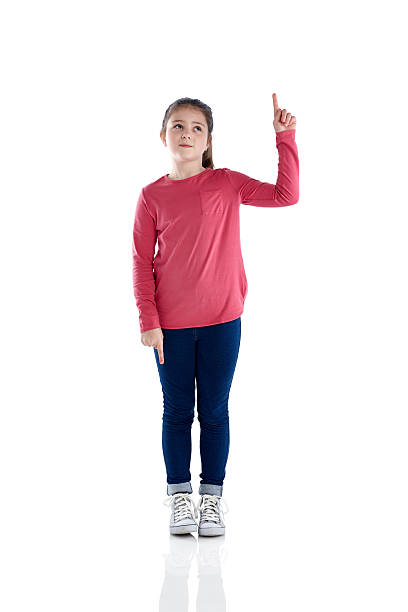 istock Innocent little young girl pointing up at copyspace 473675310