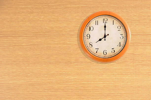 istock Clock showing 8 o'clock on a wooden wall 473675638