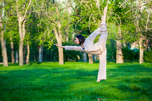 istock Practicing yoga in the morning, with trees  background 473675934