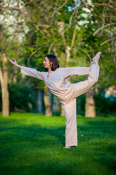istock Practicing yoga in the morning, with trees  background 473675938