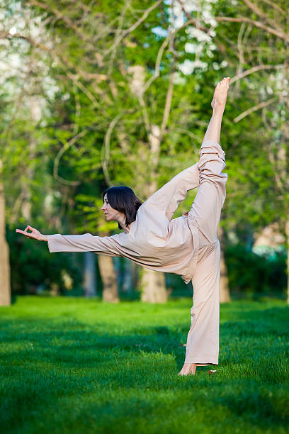 istock Practicing yoga in the morning, with trees  background 473675944