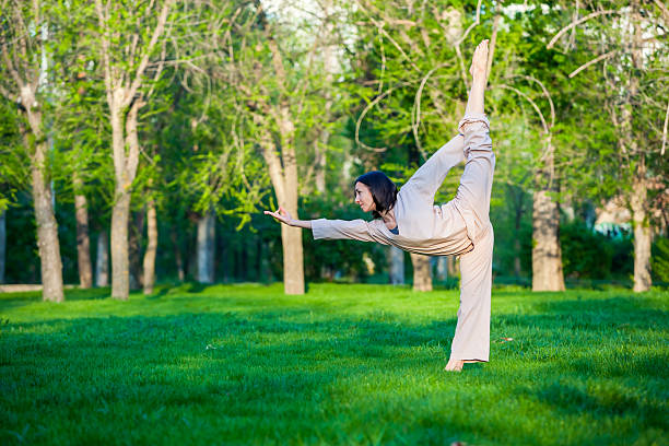 istock Practicing yoga in the morning, with trees  background 473675946