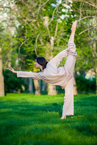istock Practicing yoga in the morning, with trees  background 473675950