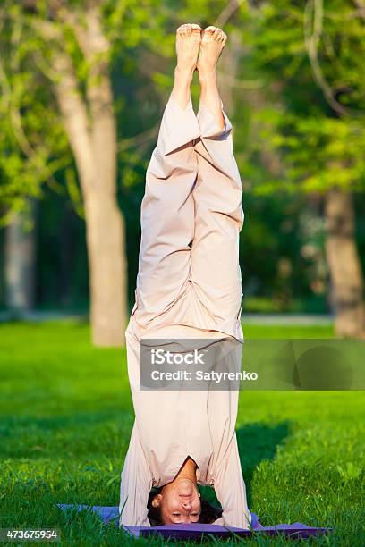 Practicing Yoga In The Morning With Trees Background Stock Photo - Download Image Now