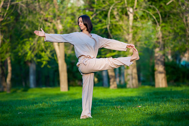 istock Practicing yoga in the morning, with trees  background 473676796