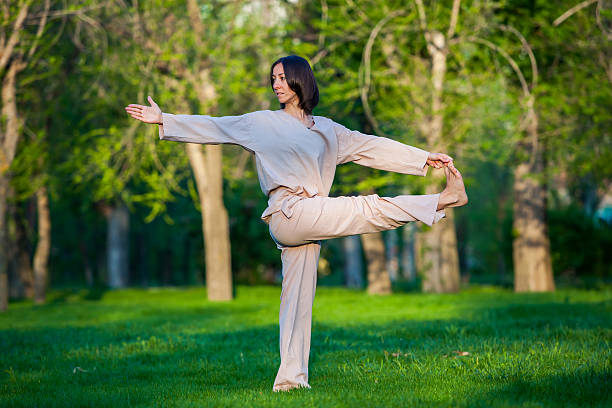 istock Practicing yoga in the morning, with trees  background 473676798