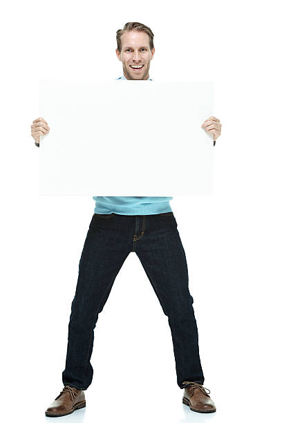 istock Smiling casual man holding placard 473677352