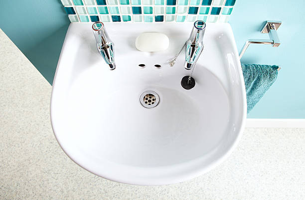 White sink in contemporary home bathroom Top view of white sink with two tap and soap in contemporary home bathroom bathroom sink photos stock pictures, royalty-free photos & images