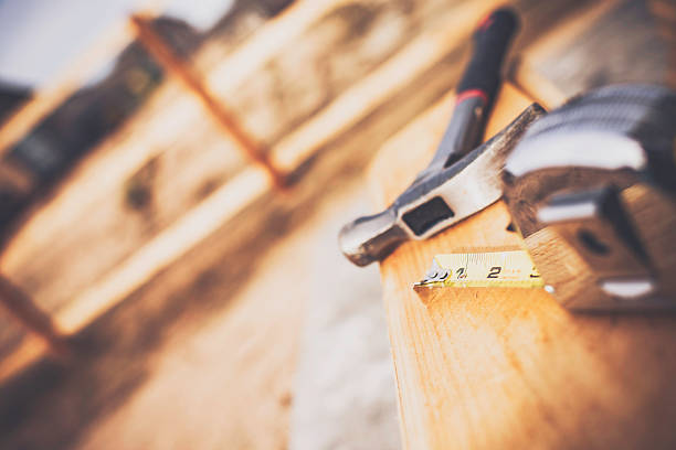 New fence construction series. Framework for picket placement. DIY New fence construction series. Framework for picket placement. DIY. Hammer and tape measure in foreground yard measurement stock pictures, royalty-free photos & images