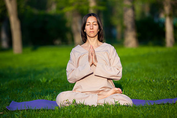 istock Practicing yoga in the morning, with trees  background 473678230
