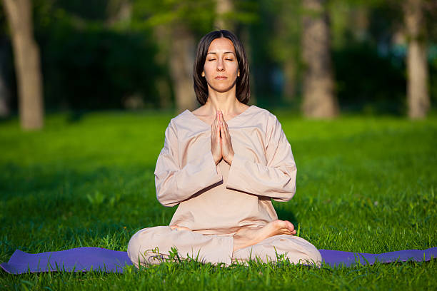 istock Practicing yoga in the morning, with trees  background 473678232