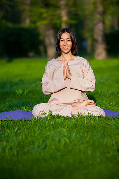 istock Practicing yoga in the morning, with trees  background 473678236