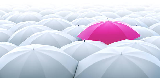 ombrello rosa diversi - standing out from the crowd individuality umbrella contrasts foto e immagini stock