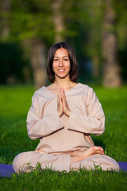 istock Practicing yoga in the morning, with trees  background 473678276