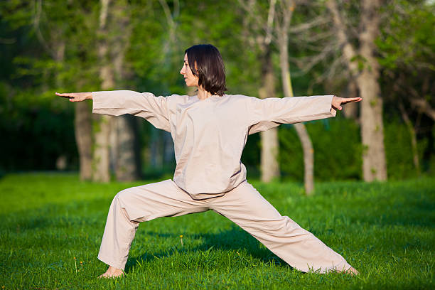istock Practicing yoga in the morning, with trees  background 473678406