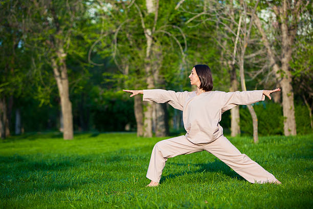 istock Practicing yoga in the morning, with trees  background 473678418