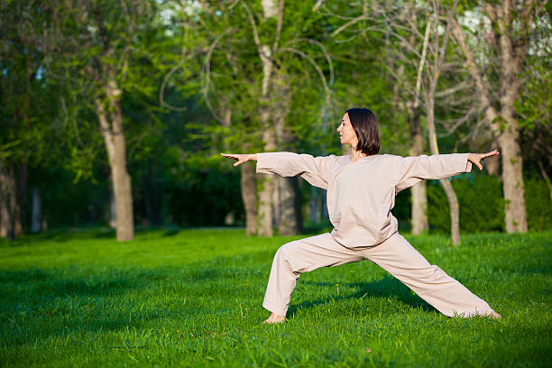 istock Practicing yoga in the morning, with trees  background 473678464