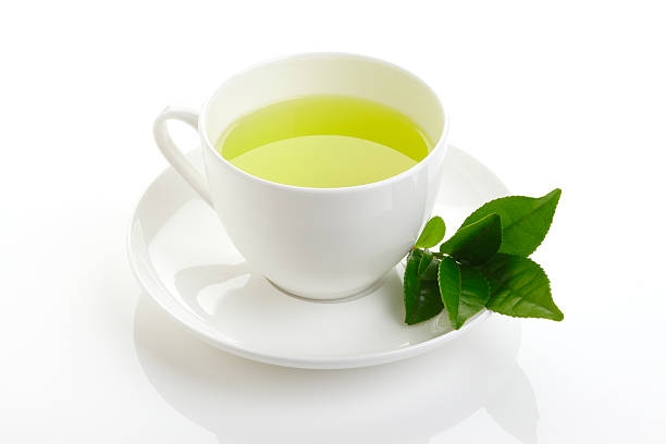 istock green tea and fresh green tea leaves 473678622