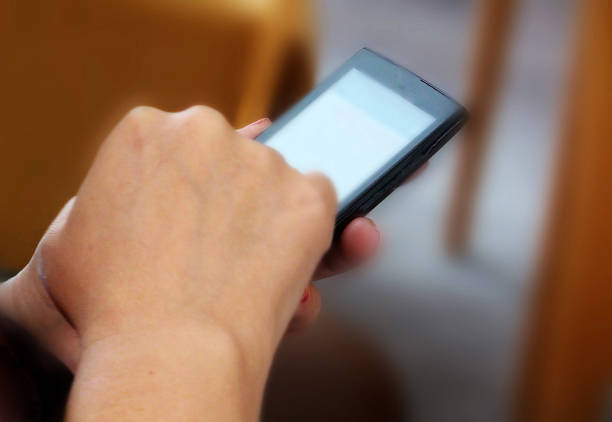 Close-Up Of Hands With Smartphone