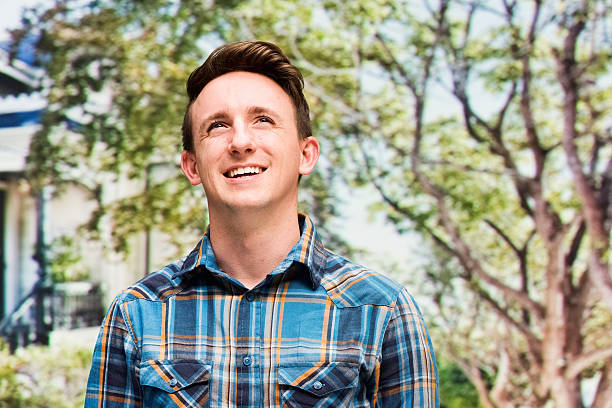 istock Cheerful casual man outdoors and looking away 473683894