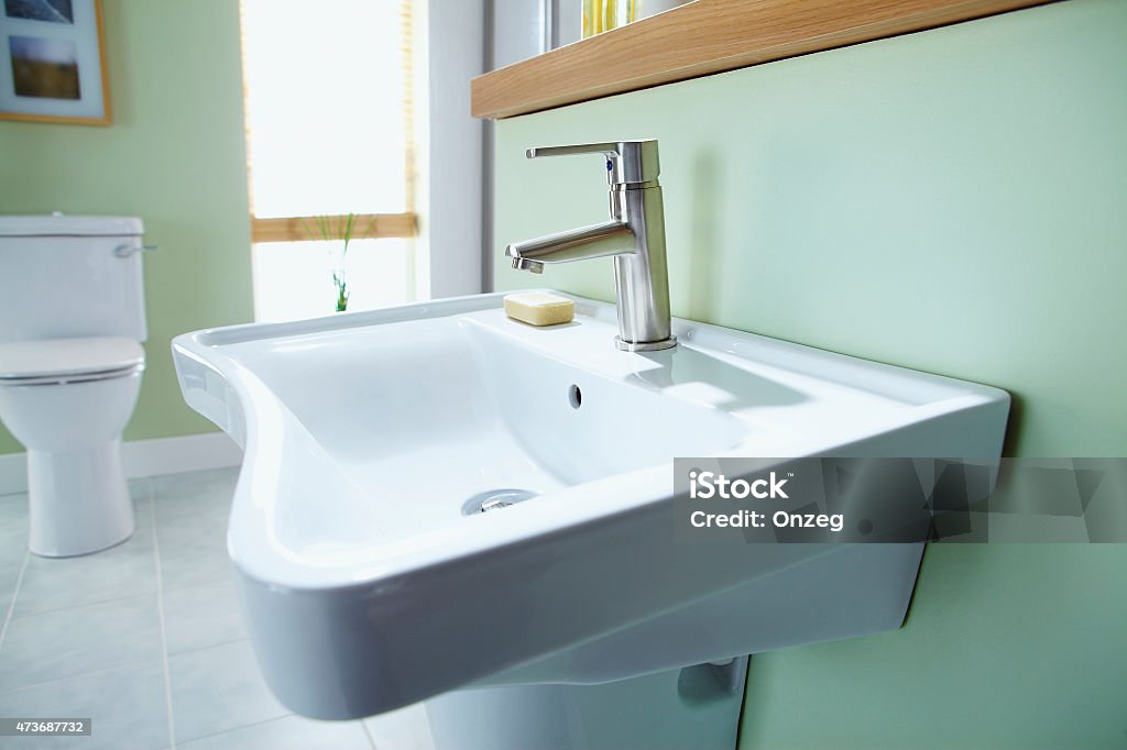 Sink in contemporary home bathroom Nice clean white sink with modern tap and soap  in contemporary home bathroom 2015 Stock Photo