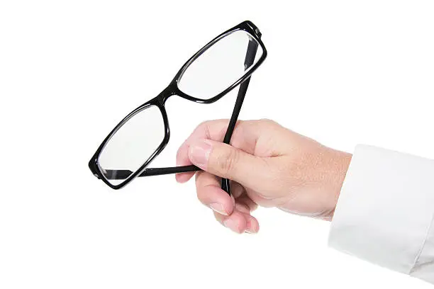 Hand Holding Eyeglasses on Isolated White Background