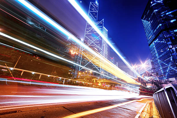 istock traffic light trails in modern city street 473695420