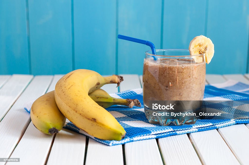 Healthy homemade banana juice in glass and fresh bananas on Healthy homemade banana juice in glass and fresh bananas on light wooden background. Weight loss, healthy food, diet and detoxification 2015 Stock Photo